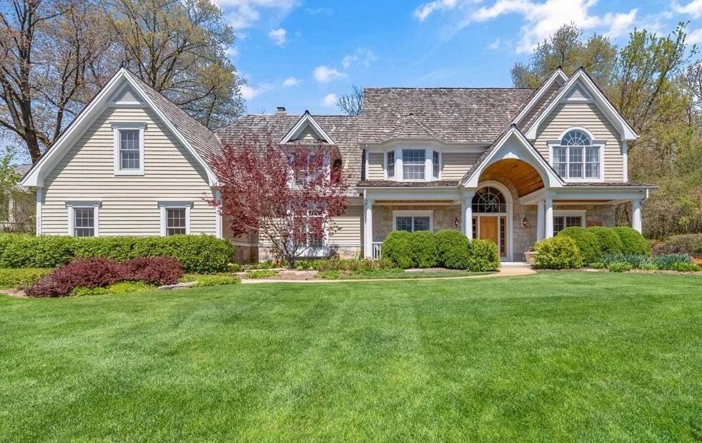 Freshly mowed striped front lawn with crisp edging at a suburban home